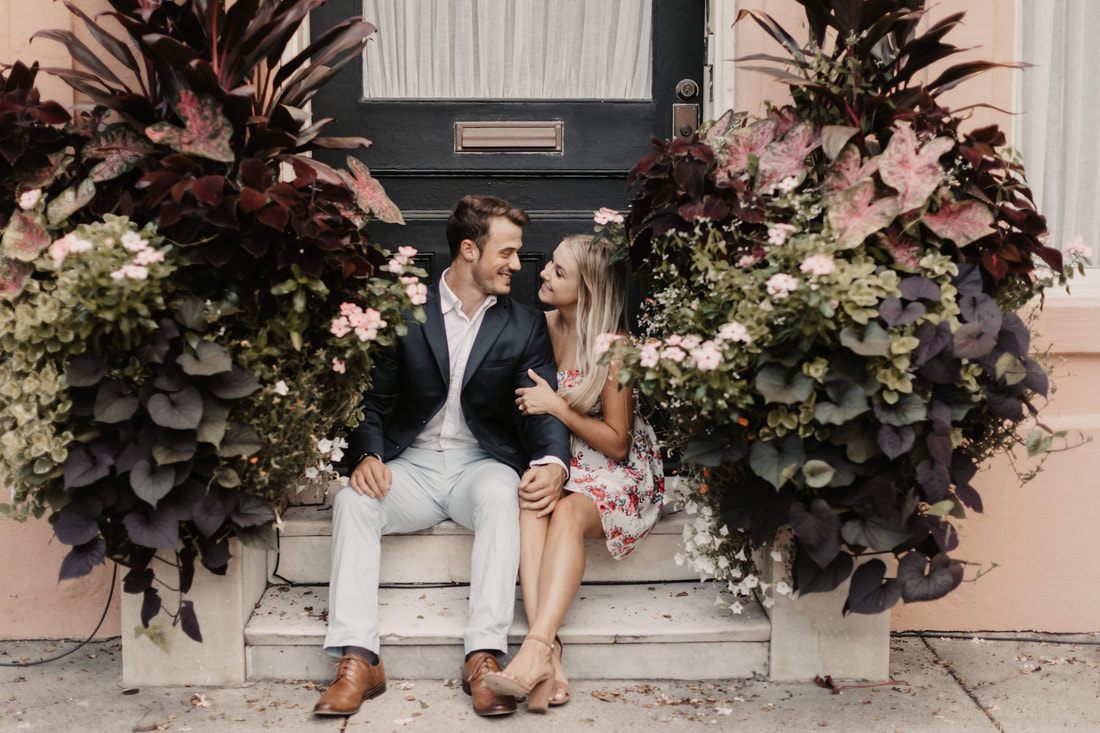 Alex and Jessica walking hand in hand along a historic Charleston street