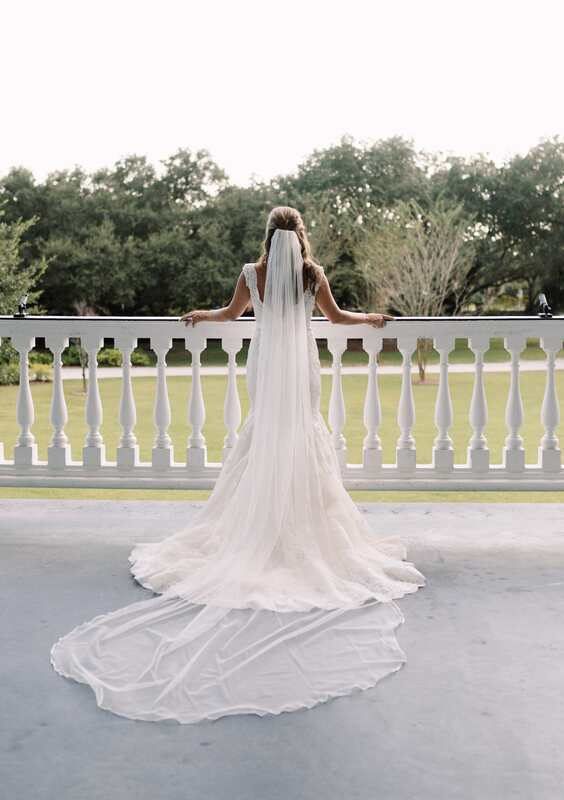 Bridal portrait of Lauren looking over her shoulder against the plantation's Southern architecture