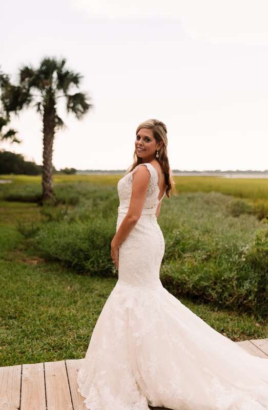 Lauren walking along a moss-draped path during her Charleston bridal session