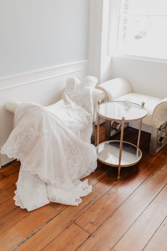 Bride looking out a tall window during getting-ready photos