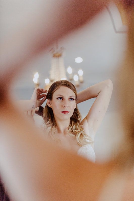 Bride adjusting her earring before the Charleston soiree