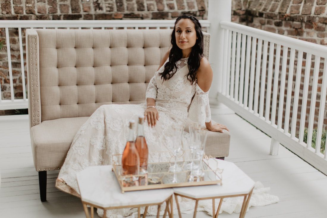 Bride smiling into a vanity mirror at Gadsden House