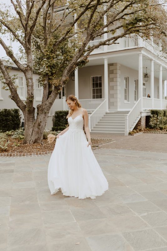 Bride glancing out a Gadsden House window in soft morning light