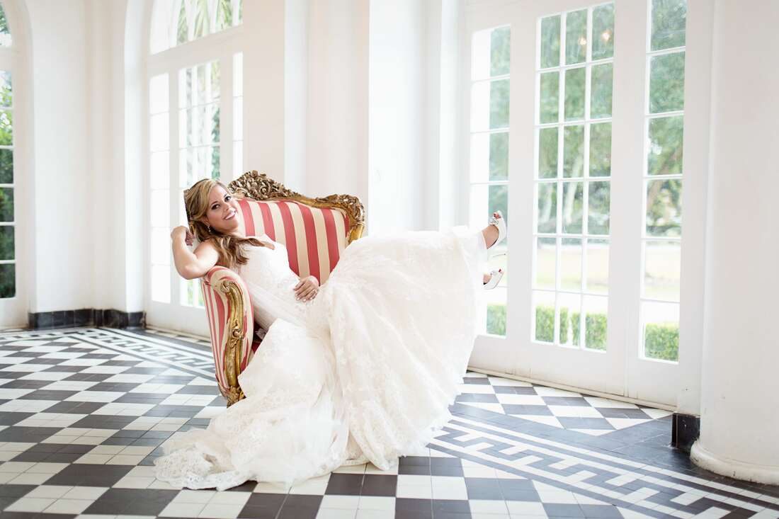 Lauren posing in her wedding gown on the grounds of the Lowndes Grove Plantation