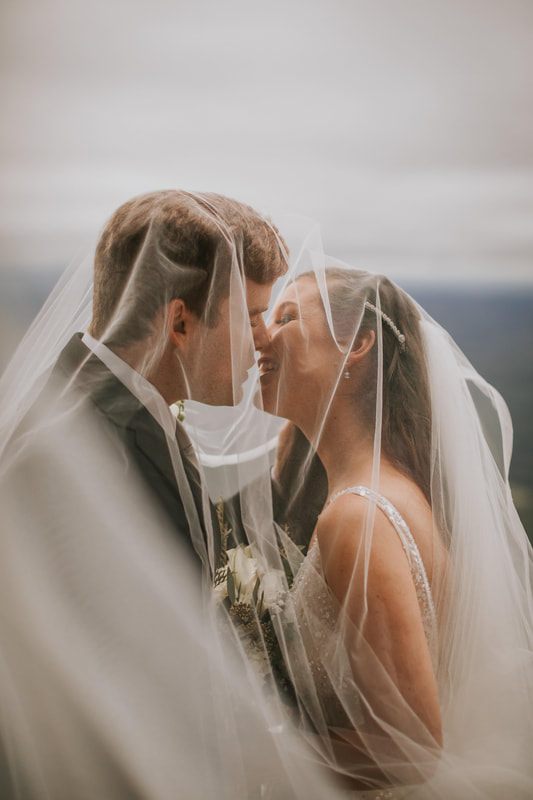Cassandra and Charlie stand together overlooking the Blue Ridge Mountains.