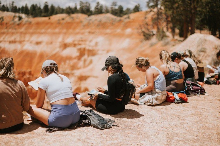 Women gathered around the fire in the Utah desert