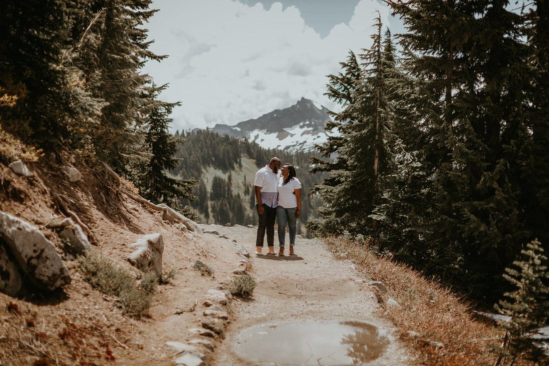 Tyeisha and Adam sharing a quiet moment against the Mt. Rainier landscape