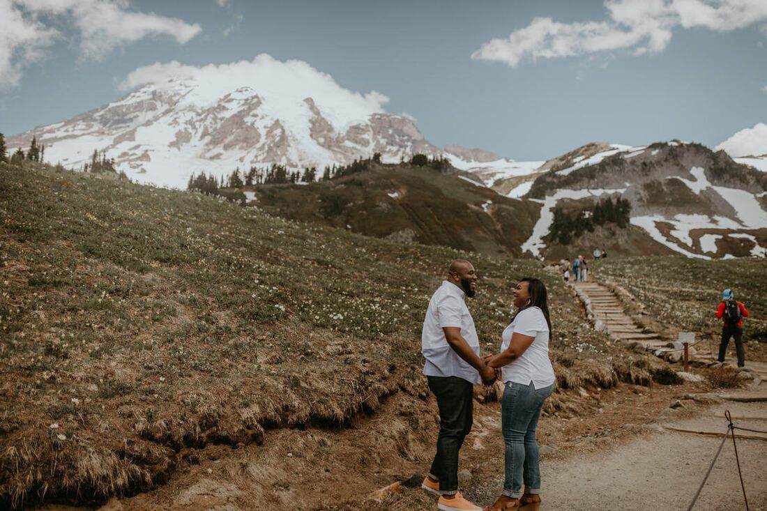 Tyeisha and Adam sharing a quiet moment against the Mt. Rainier landscape