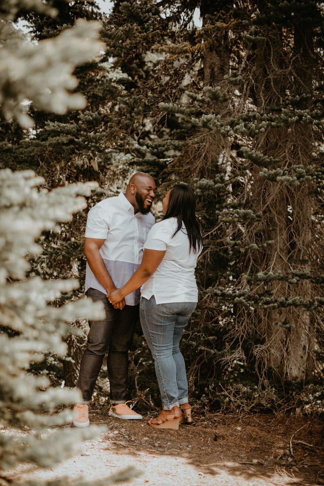 Close-up portrait of the couple laughing together on the mountainside