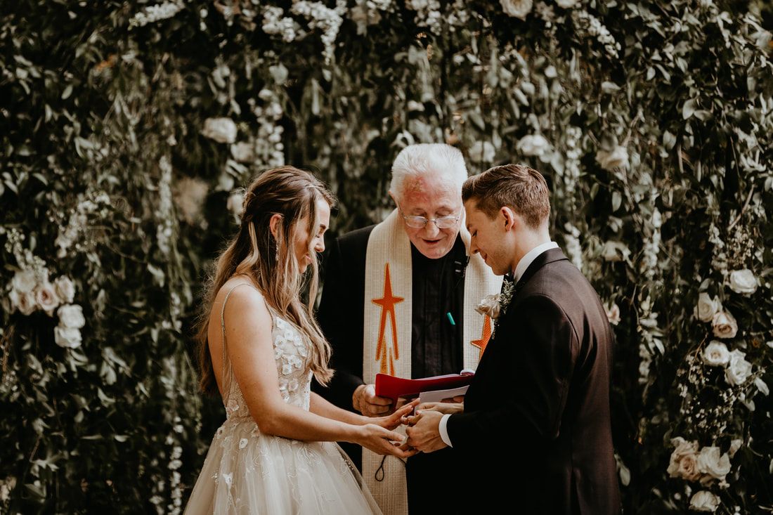 Bride laughing candidly in her wedding gown outdoors
