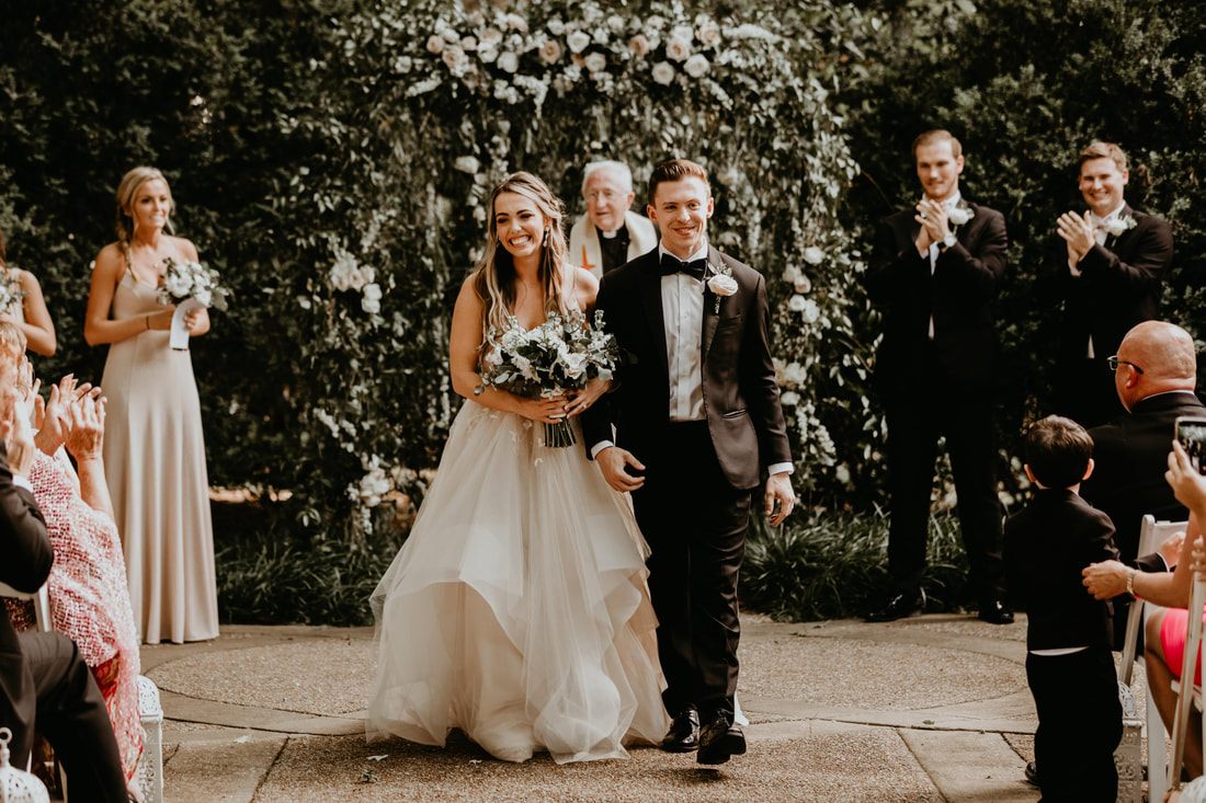 Groom watching his bride walk down the aisle