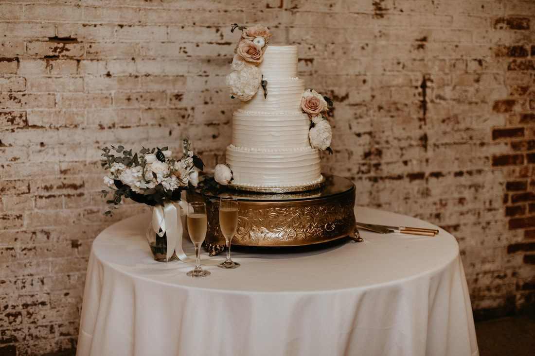 Reception table setting with earth-tone florals and greenery