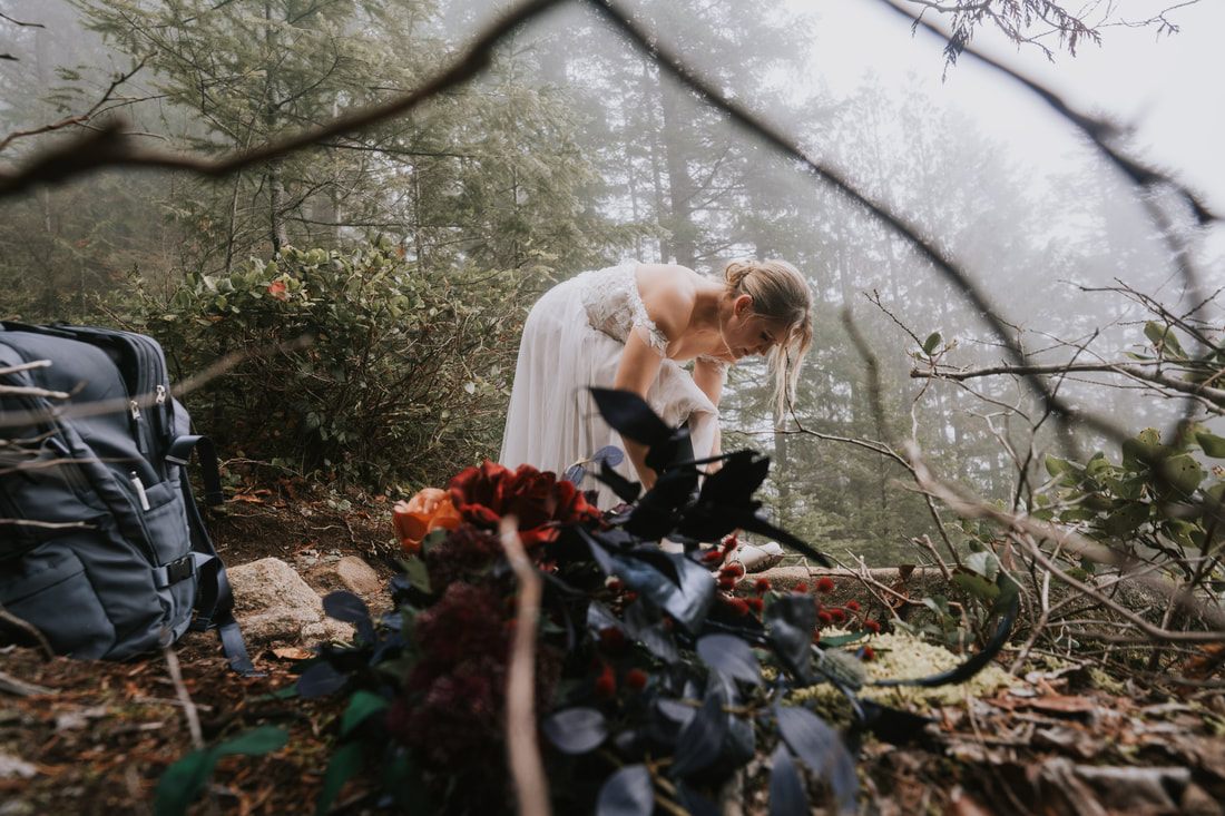 The couple exchanging vows on the Heybrook Lookout Trail in thick fog.