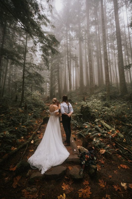The couple exchanging vows on the Heybrook Lookout Trail in thick fog.