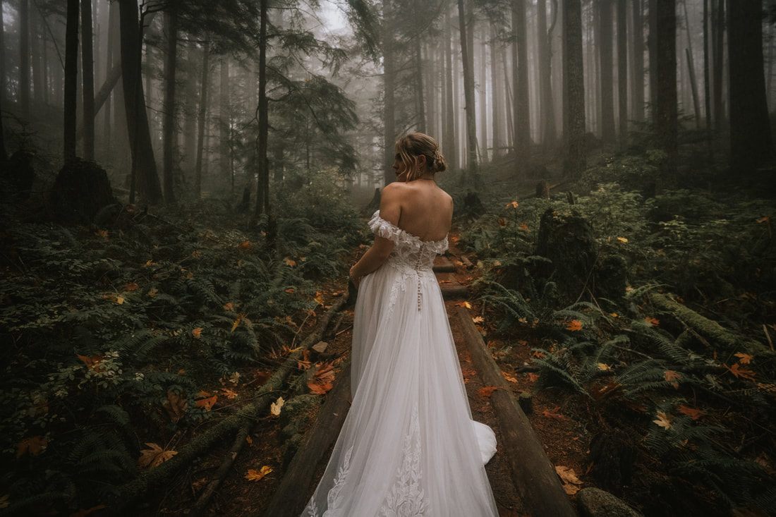Bride and groom walking together on the fog-covered Heybrook Lookout Trail.