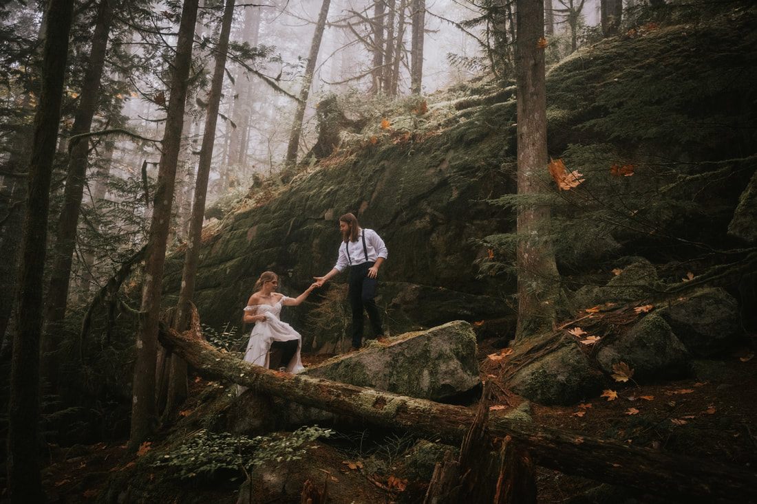 Close-up portrait of the couple during their moody forest elopement ceremony.