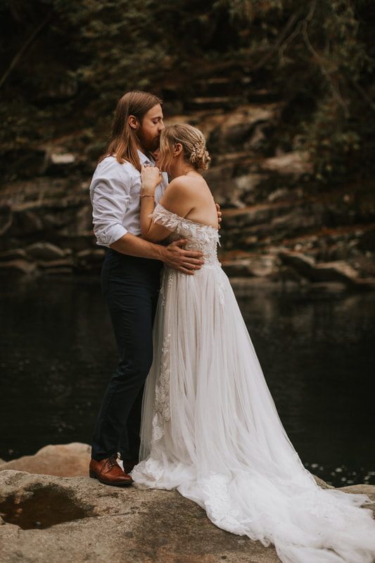 Bride and groom walking together on the fog-covered Heybrook Lookout Trail.