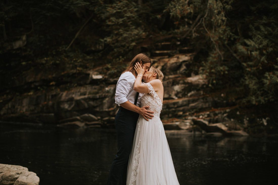 Close-up portrait of the couple during their moody forest elopement ceremony.