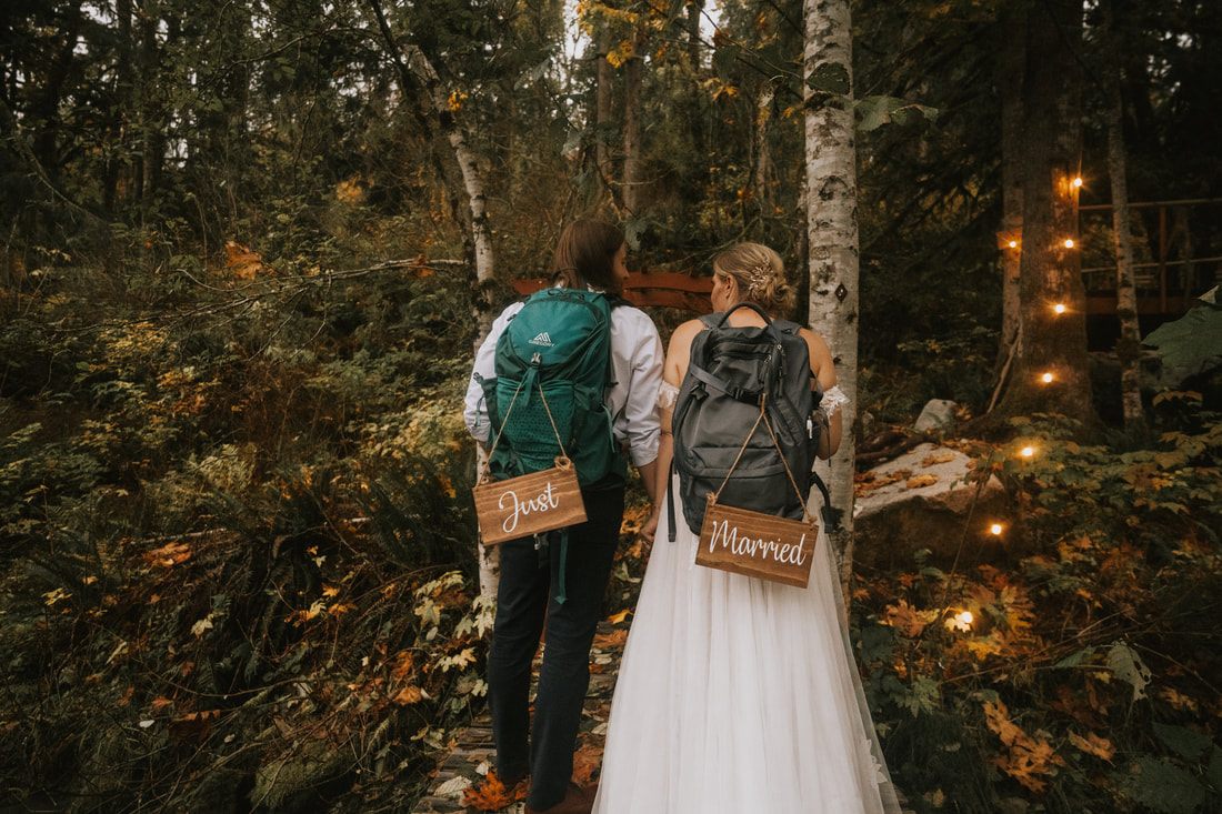 Close-up portrait of the couple during their moody forest elopement ceremony.