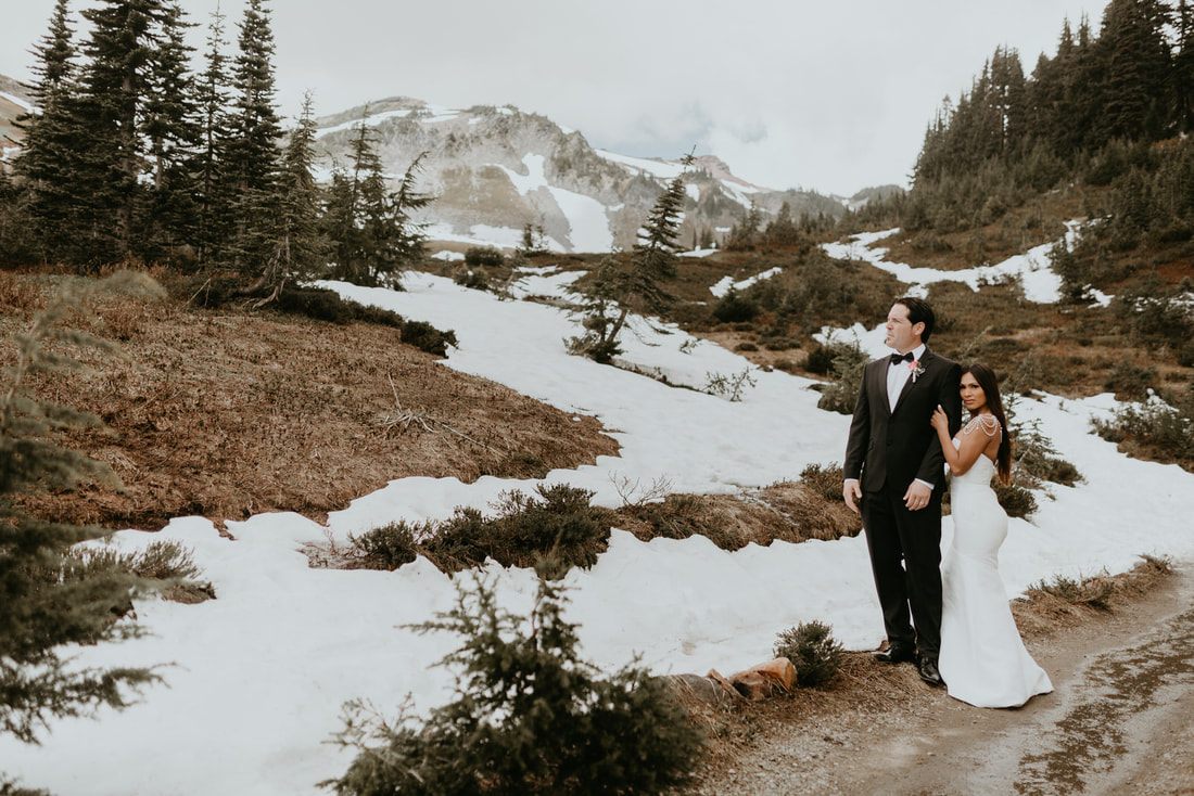 Couple posing with Mt. Rainier in the background during their Washington elopement