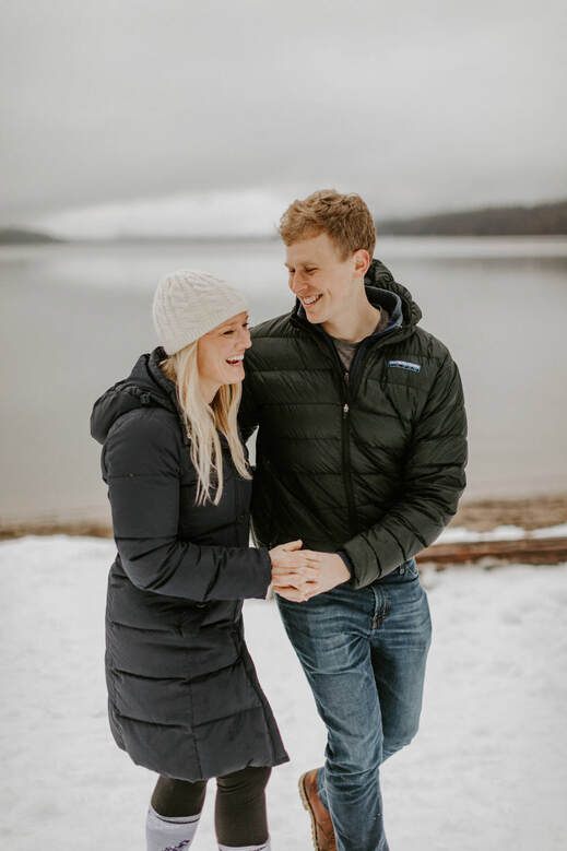 Couple embracing outside a PNW a-frame cabin near Lake Wenatchee