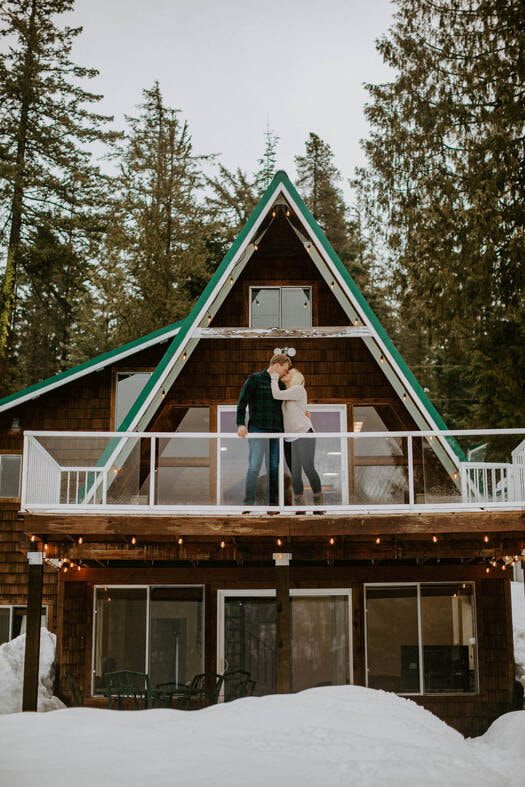 Couple standing together outside their Washington a-frame cabin