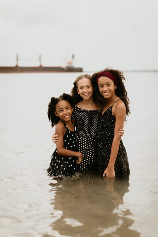 Nicole and Deno Mickle sharing a candid moment with their three daughters