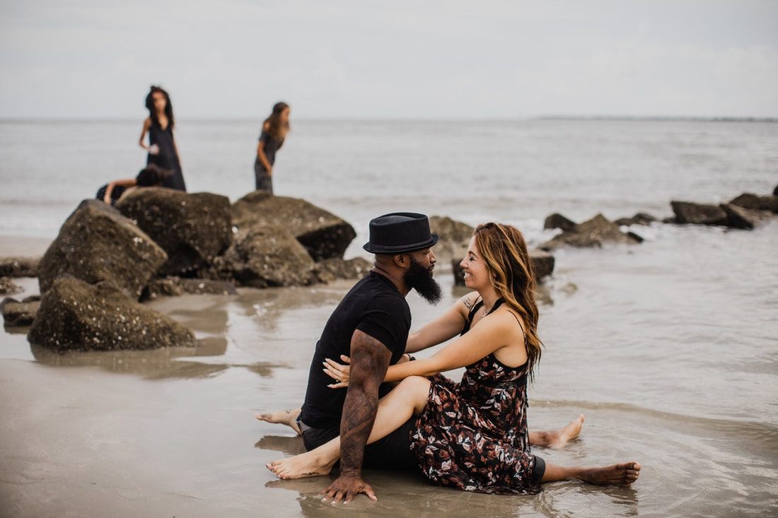 Sisters exploring the shoreline during a unique Charleston family session