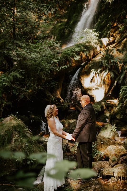 Chris and Shannon pose together in front of a waterfall in Olympic National Park.
