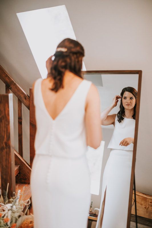 Groom kissing his bride's forehead during their elopement ceremony