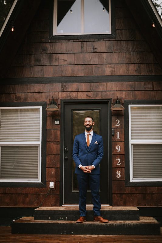 Bride and groom holding hands beside the lake at their PNW cabin elopement