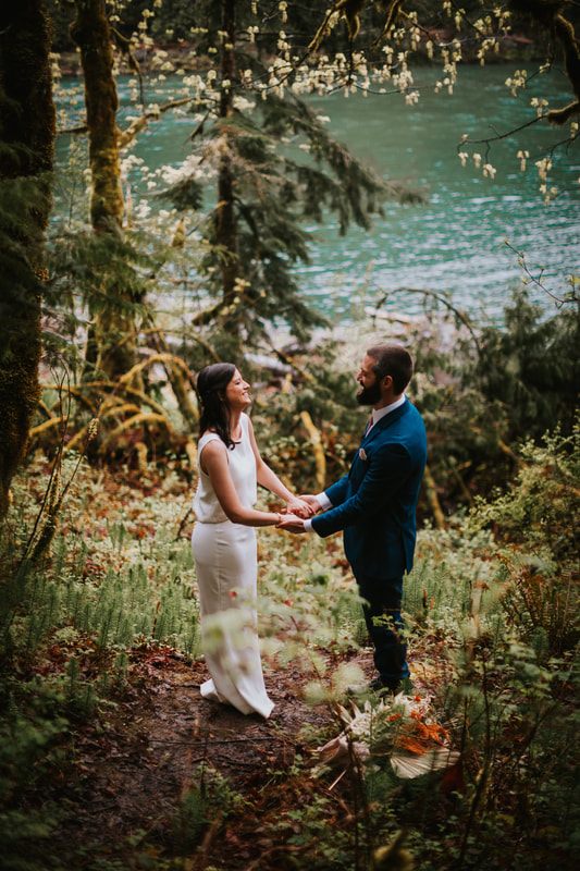 Couple toasting champagne during their PNW cabin elopement celebration