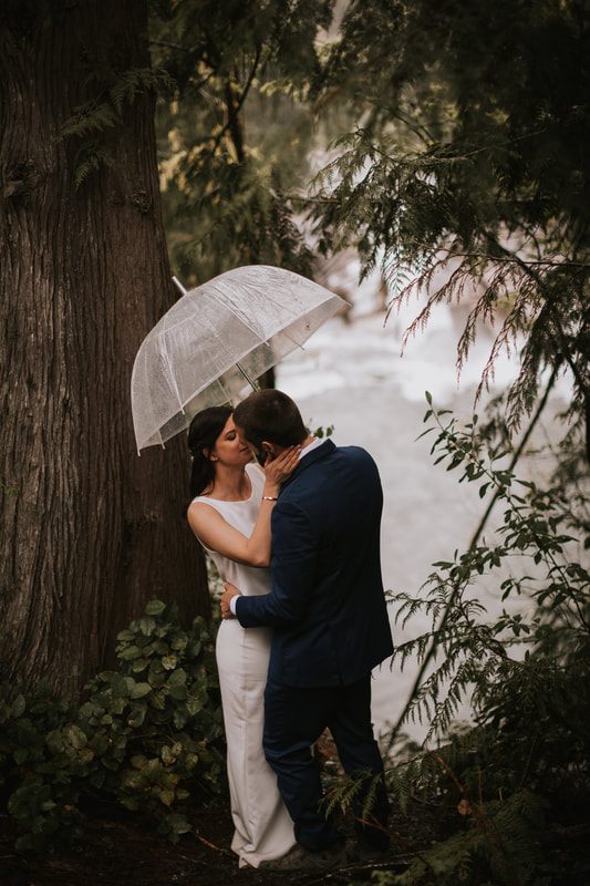 Newlyweds slow dancing outside their A-frame cabin at sunset