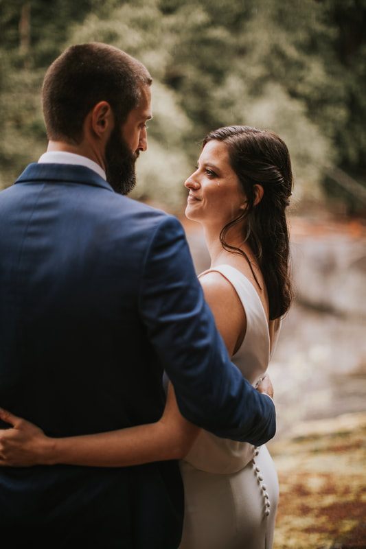 Groom kissing his bride's forehead during their elopement ceremony
