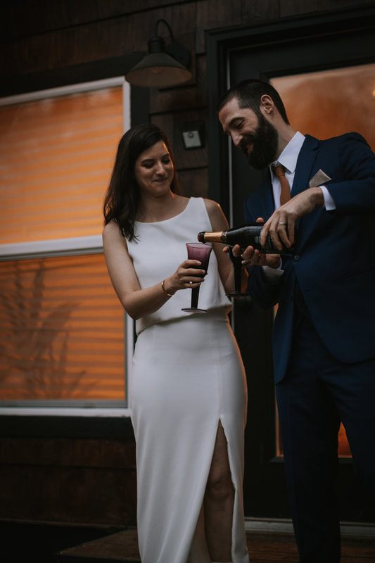 Bride laughing with her groom during their intimate cabin elopement
