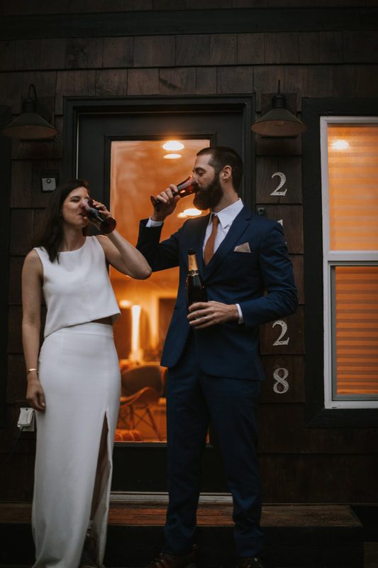 Couple toasting champagne during their PNW cabin elopement celebration