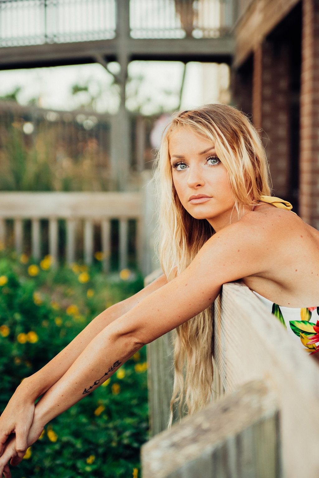 Lindsey O. modeling Cheeky Swim swimwear, posing against a scenic backdrop, for an international campaign shoot.