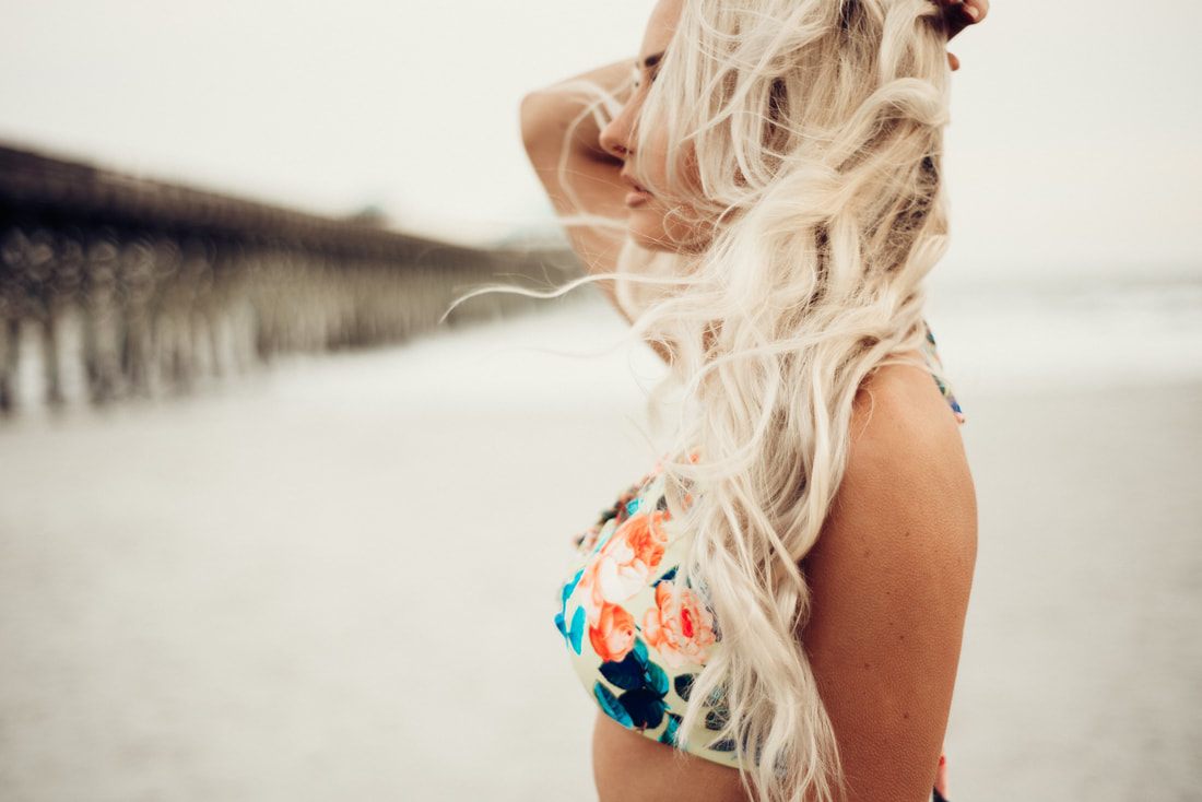 Lindsey O. modeling Cheeky Swim swimwear, posing against a scenic backdrop, for an international campaign shoot.