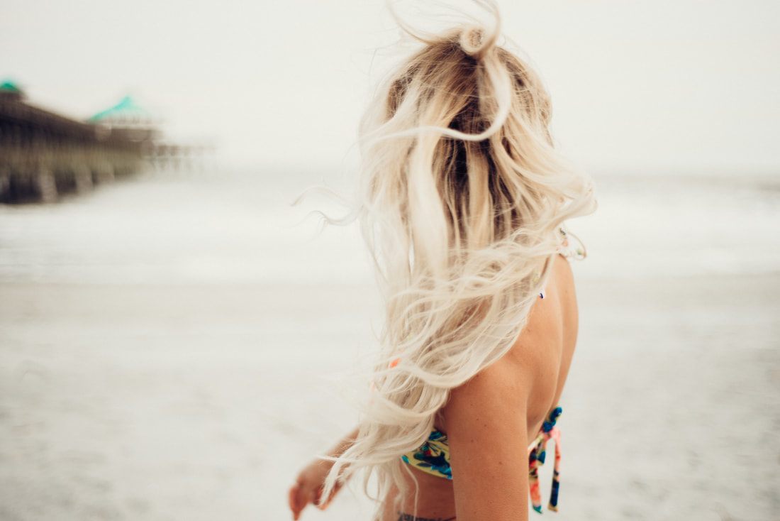 Lindsey O. modeling Cheeky Swim swimwear, posing near the waterline, for an international campaign shoot.