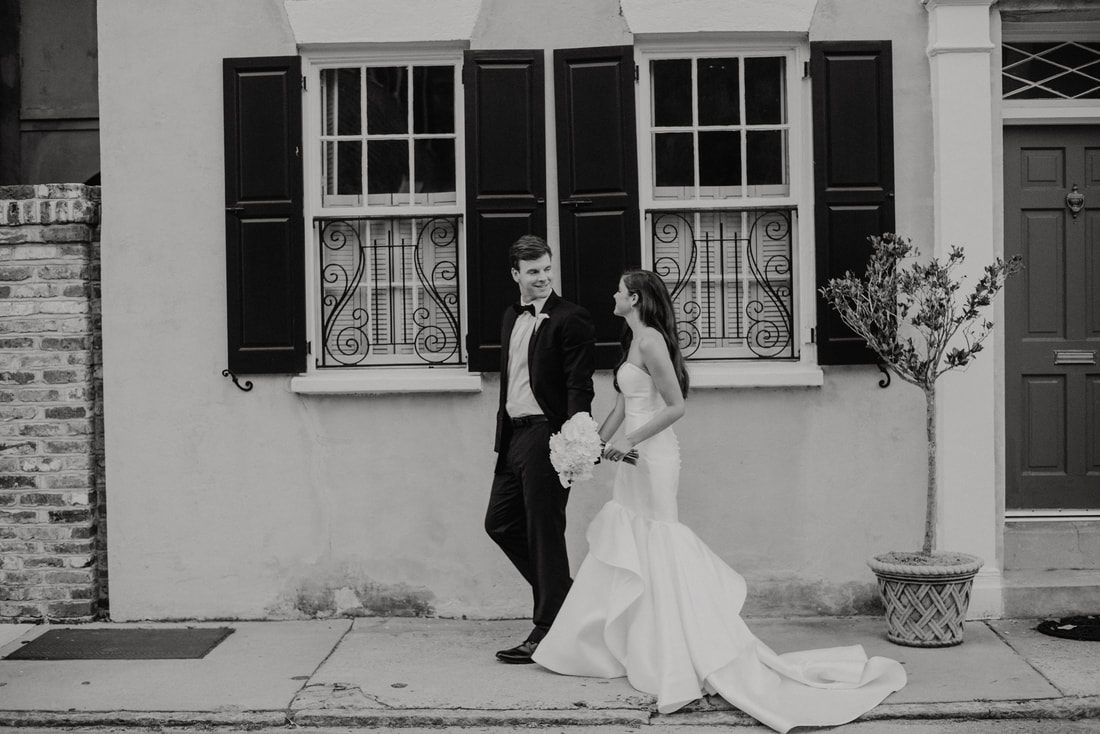Groom and groomsmen posing on a colorful Charleston side street