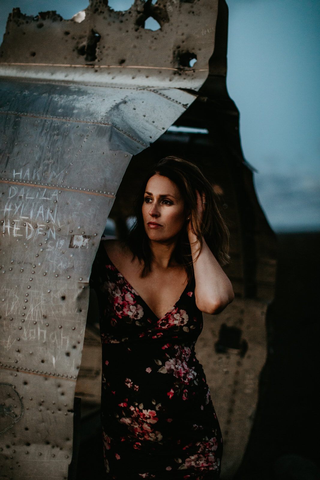 Moody maternity portrait lit against the dark Icelandic sky