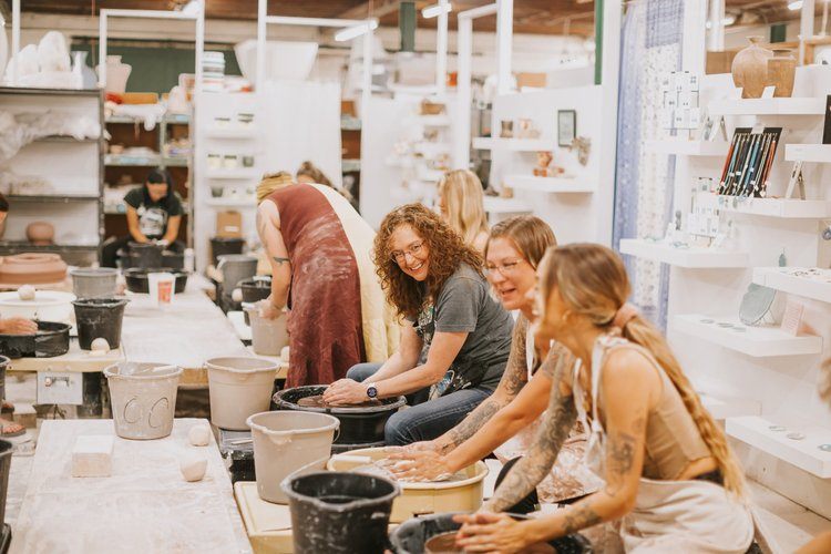 Women gathered at a downtown Asheville brewery after a hike
