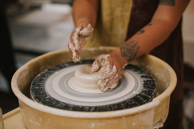 Throwing bowls at a pottery wheel in the River Arts District
