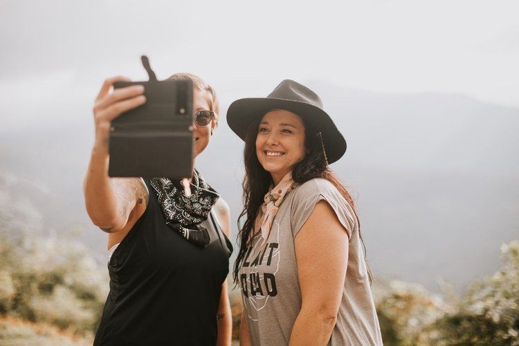 Women gathered at a downtown Asheville brewery after a hike