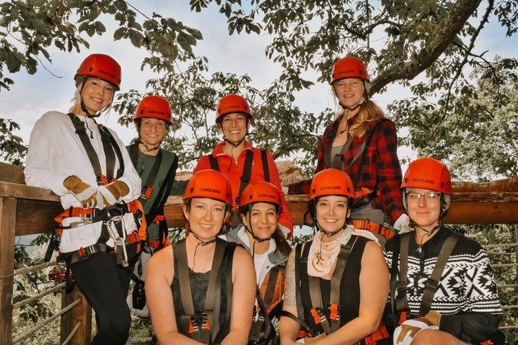 Women gathered at a downtown Asheville brewery after a hike