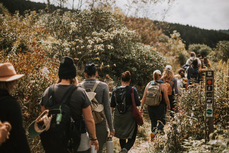 Women gathered at a downtown Asheville brewery after a hike
