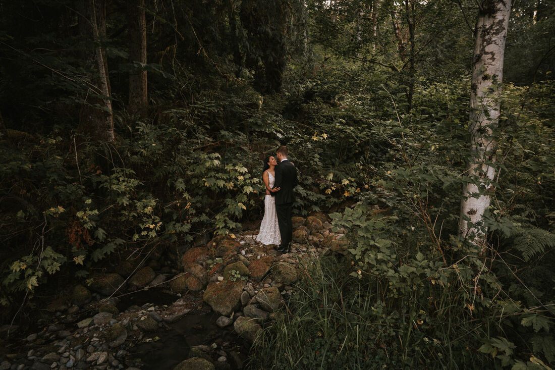 Couple embracing outside the secluded A-frame cabin in Stevens Pass