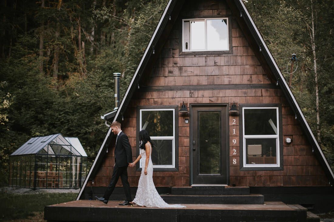 Couple relaxing on the cabin porch during their honeymoon getaway