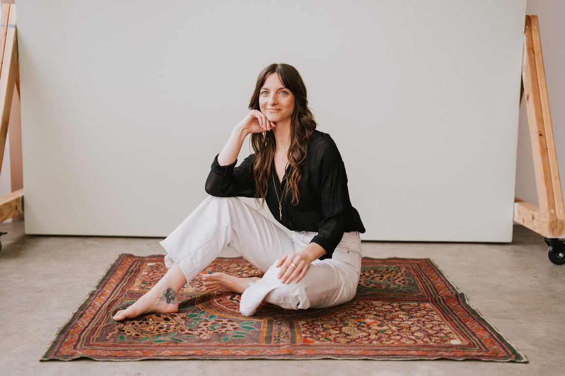 Celeste poses with a potted plant, reflecting her work as a spiritual plant guide.