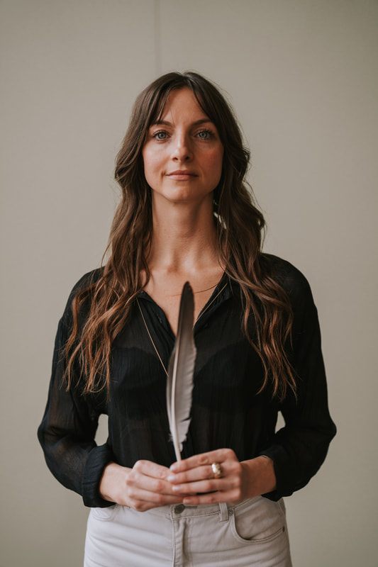 Celeste stands confidently for a branding portrait in soft studio light.